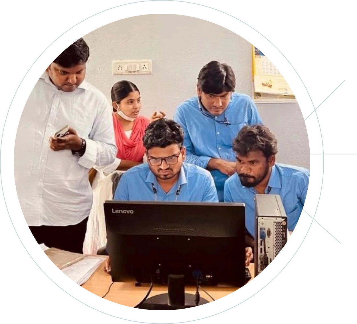 Photo of a group of people in front of a computer